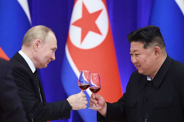 In this pool photograph distributed by the Russian state agency Sputnik, Russian President Vladimir Putin and North Korean leader Kim Jong Un toast during a reception at the Mongnangwan Reception House in Pyongyang on June 19, 2024. Putin enjoyed a red carpet welcome, a military ceremony and an embrace from North Korea's Kim Jong Un during a state visit to Pyongyang where they both pledged to forge closer ties. (Photo by Vladimir Smirnov / POOL / AFP) / -- Editor's note : this image is distributed by the Russian state owned agency Sputnik --